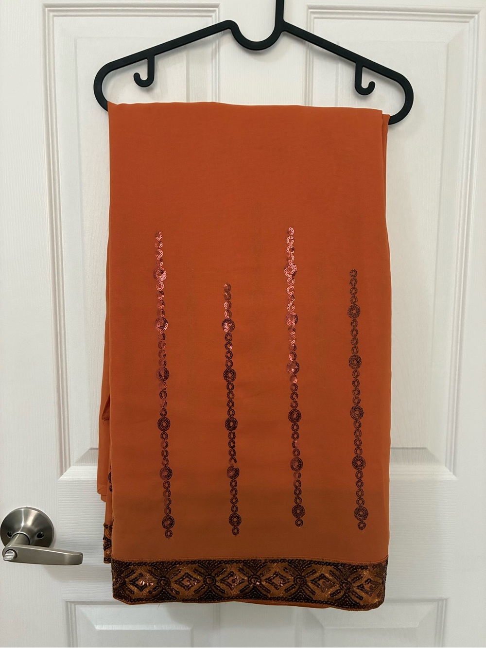 Orange saree with bronze/brown accents